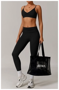 Close-up detail of high-elastic black yoga set featuring V-neck sports bra and high-waist pants