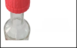 Detailed close-up of a red little hat wine stopper with realistic knitted texture