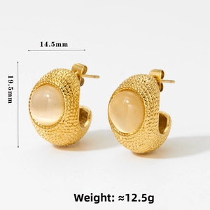 Detail view of 19.5mm gold C-shaped earrings with embossed texture and natural cat eye stone