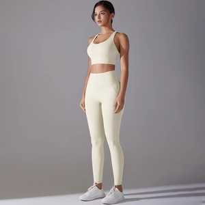 Detailed view of cream-colored backless sports bra and high-waisted yoga leggings