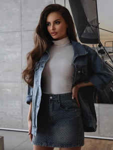 Close-up of grey polka dot denim skirt set featuring high-waisted fit and fabric texture