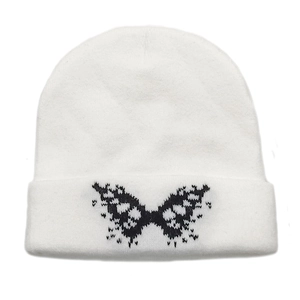 Detailed view of white ribbed knit beanie featuring a black butterfly pattern