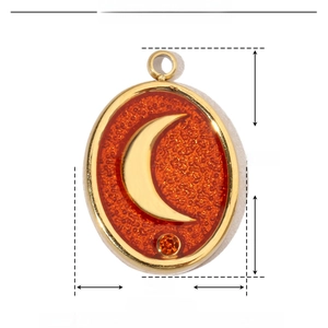 Detailed view of 17mm gold stainless steel moon pendant with orange enamel and rhinestone