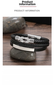 Detail view of a men's black woven leather bracelet with stainless steel knot charms