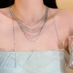Elegant multi-layer silver choker necklace with starry chain design on female model