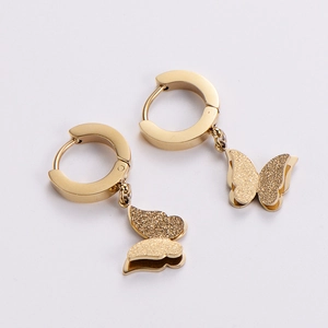 Chic golden butterfly hoop earrings with frosted texture wings on a white background