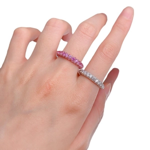 Eternity bands with pink and white pavé cubic zirconia on model hands, luxury style
