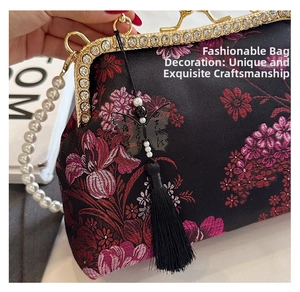 Close-up of beaded shell bag with floral embroidery, pearl handle and silk tassel