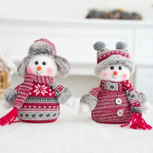 Detail of Christmas snowman figurines with red knit hats and wooden button accents