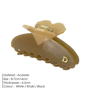 Khaki acetate shark hair claw clip with golden D detail for elegant women styling