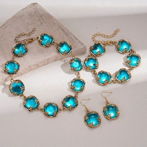 Ensemble collier bracelet et boucles d'oreilles vintage doré avec résine bleue ronde