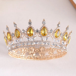 Detailed close-up of a golden bridal crown featuring pear-cut yellow crystals and filigree