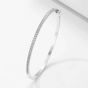 Elegant minimalist silver bangle featuring micro-set cubic zirconia and side clasp