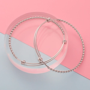 Minimalist adjustable silver stainless steel bangle set with twisted rope and sleek patterns