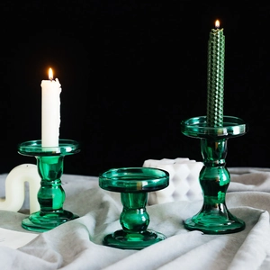 Set of three vintage green glass candle holders in different heights for home decor