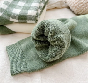 Close-up of the thick green terry lining on winter socks for warmth and comfort