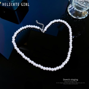 Elegant white pearl necklace with adjustable silver lobster clasp on a black background
