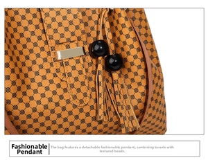 Close-up of caramel brown tote bag with star patterns and detachable tassel charm