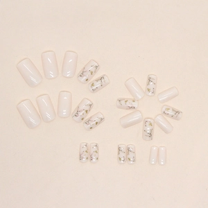 Chic cream white press-on nails with delicate green leaves and pink floral nail art designs