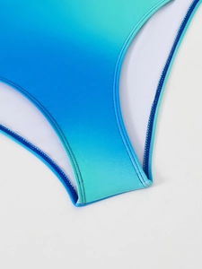 Detailed macro view of gradient blue swimsuit fabric with reinforced double stitching