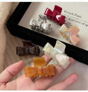 Set of small acetate bow hair claws in six colors including marble and tortoiseshell