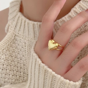 Detail of 925 sterling silver heart ring with double-layered band on a knit background