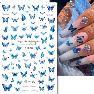 Detailed blue butterfly nail art stickers shown with realistic hand application effect
