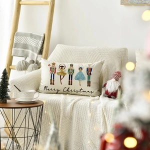 Linen Christmas pillowcase featuring Nutcrackers and Merry Christmas script on an armchair