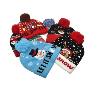 Detailed view of various Christmas knit beanies with pom-poms and holiday patterns