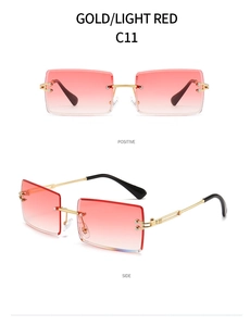 Detail view of gold metal temples and light red gradient rimless rectangular lenses