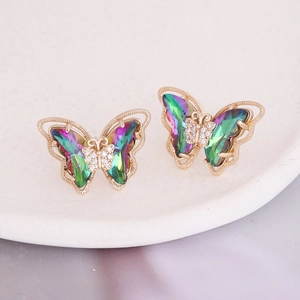 Detailed macro shot of gradient butterfly earrings with sparkling center crystals