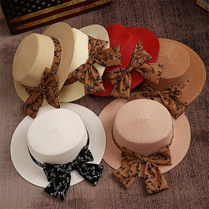 Flat top straw boater hats with floral ribbon bows in various colors for summer