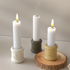 Detailed view of nautical anchor and clover relief patterns on minimalist resin candle holders