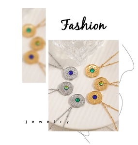 Detail of sunburst coin pendants with colorful gems on gold and silver bead chains