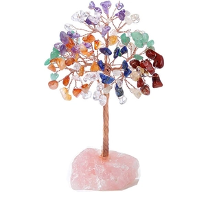 Handmade chakra crystal money tree with colorful stones on a rose quartz base