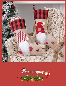 Detail of burlap Christmas stockings with gnomes and red plaid cuffs on a wooden chair