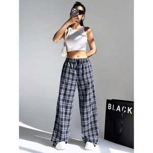 Close-up of high-waist plaid wide-leg trousers with drawstring and soft cotton texture