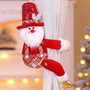 Detail showing red sequined Santa Claus curtain tieback on white sheer curtains