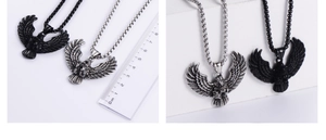 Macro shot of eagle pendant with scale ruler showing 5cm width and vintage metal details