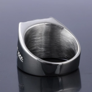 Macro detail of brushed silver stainless steel ring band with side diamond inlay