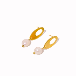 Golden oval textured hoop earrings with elegant white pearl drops on white background