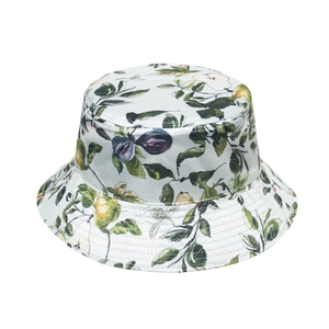 Detail of floral bucket hat featuring botanical patterns of lemons and figs on white fabric