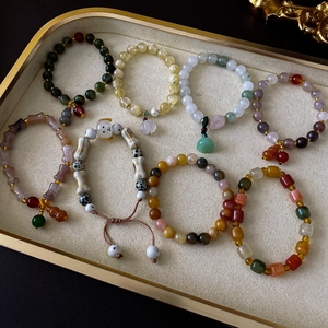 Detailed close-up of seven assorted Chinese ceramic and gemstone elastic bead bracelets