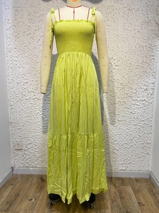 Detail showing the pleated bust and layered hem of a lime green vintage maxi dress