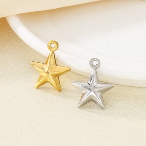 Detailed close-up of 18K gold and silver star pendants for DIY jewelry making