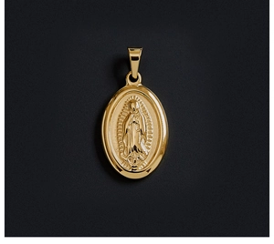 Macro detail of 18K gold plated oval Virgin Mary relief pendant with polished finish