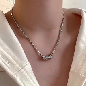 Unisex titanium steel woven chain necklace with sparkling zircon rings on white shirt