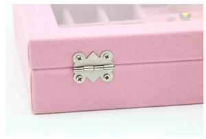 Detailed macro view of the sturdy silver metal hinges on a pink velvet jewelry box
