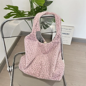 Detailed view of pink leopard print faux fur tote bag with checkered lining