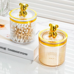 Clear food storage jars with gold bear lids for kitchen organization and grain storage